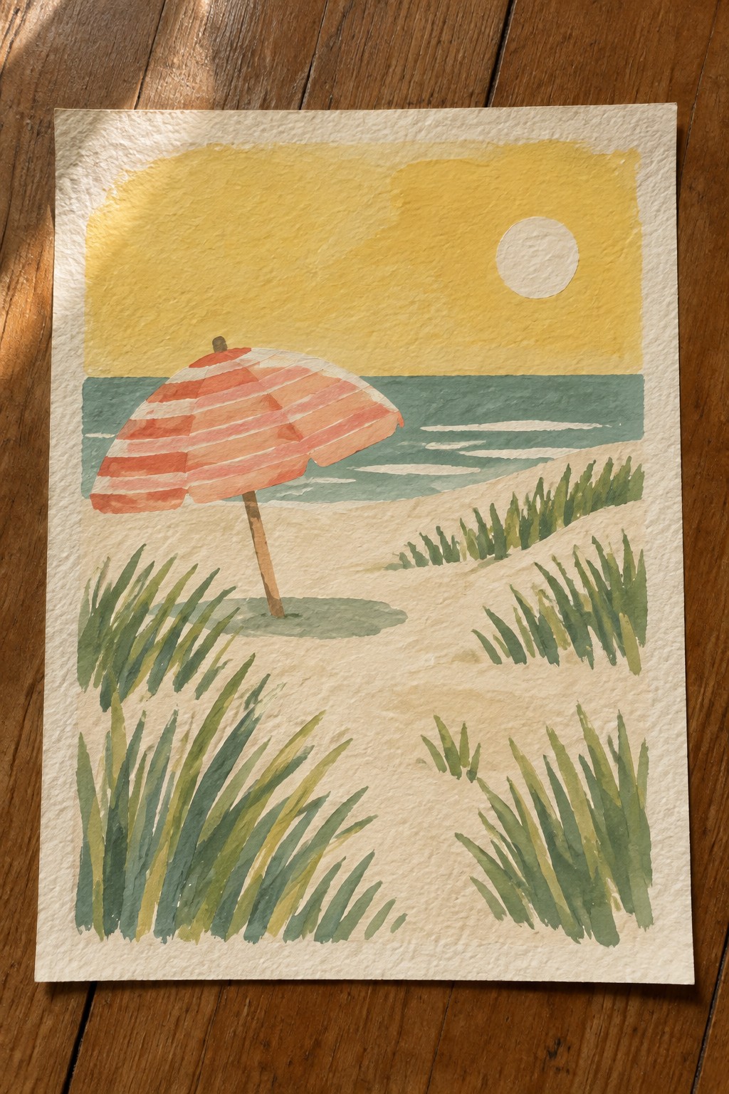 Watercolor of red-striped umbrella on beach with ocean, yellow sun, and green grass.