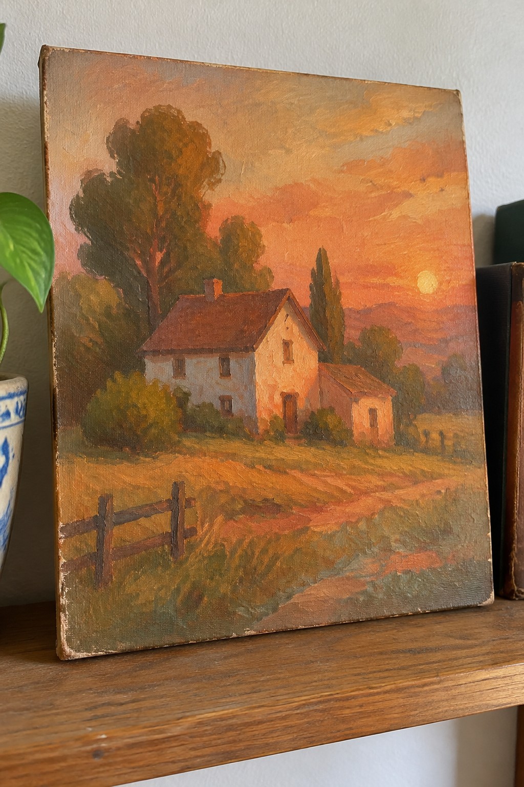 Oil painting of white farmhouse at vibrant orange sunset with trees and wooden fence