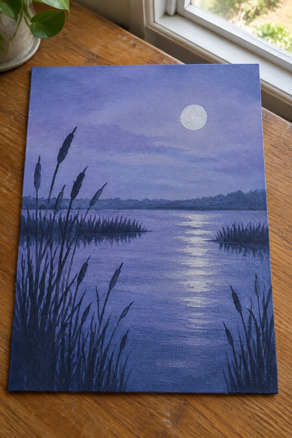 Canvas painting of moonlit purple lake with silhouetted reeds and glowing moon.