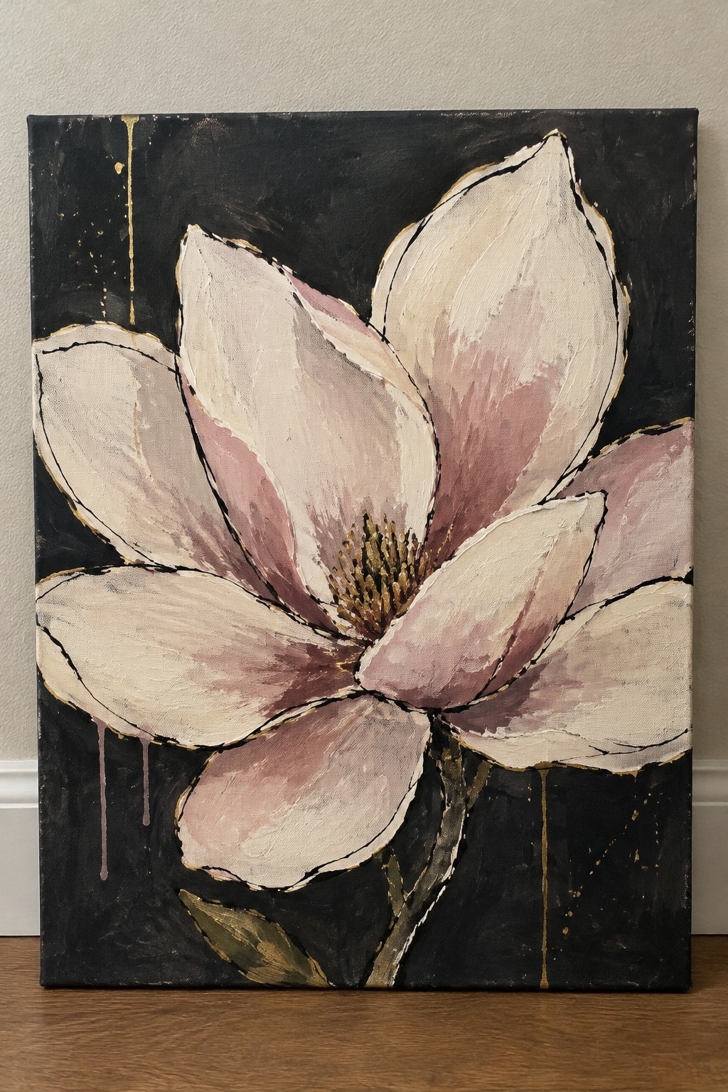 Large pink magnolia bloom with gold edges on textured black canvas with drips.