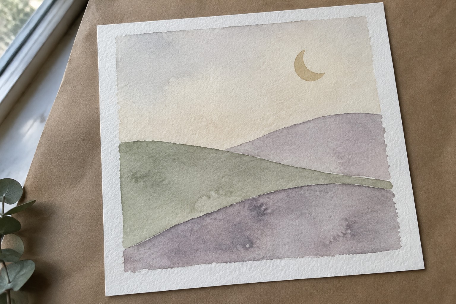 Watercolor painting of layered green and purple hills beneath a golden crescent moon