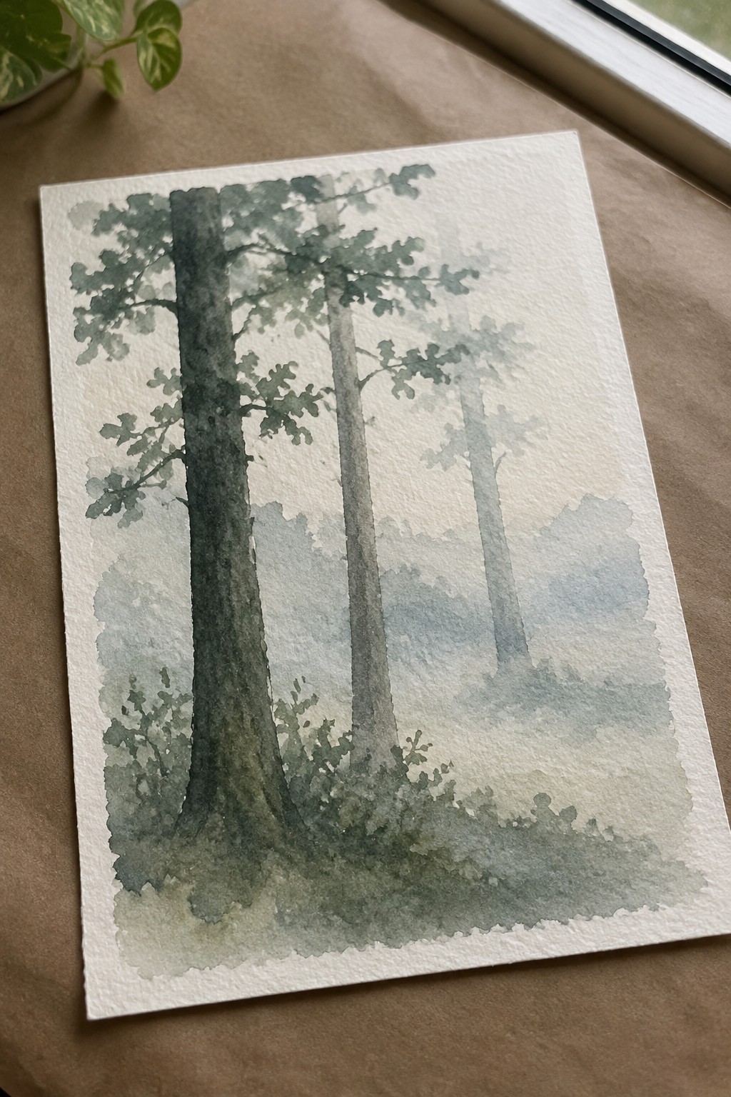 Watercolor painting of three tall trees in a misty forest on paper