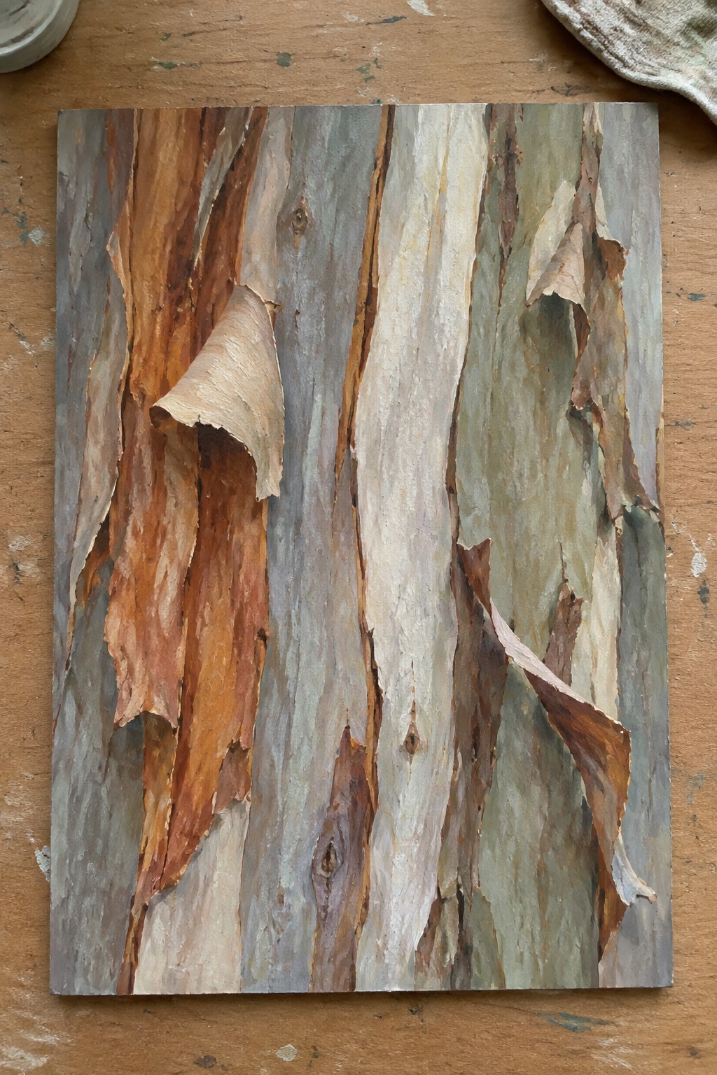 Realistic painting of peeling eucalyptus bark in brown, gray, and white tones