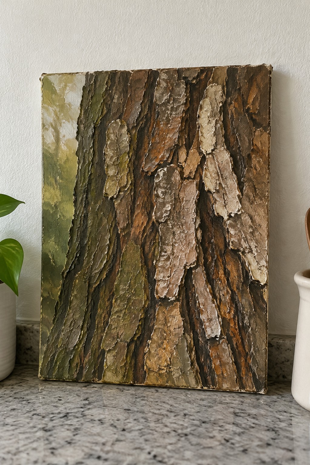 Thick impasto painting of tree bark in browns, greens, and white on marble counter