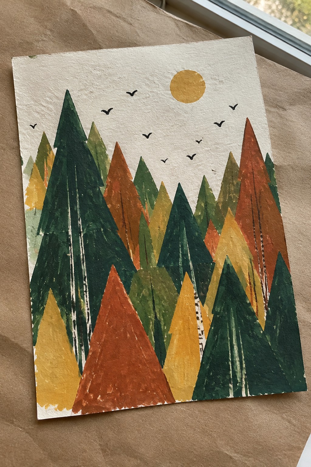 Vibrant abstract forest with colorful triangular trees, yellow sun, and black birds.