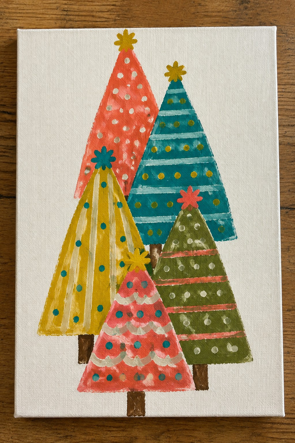 Five colorful abstract Christmas trees with stars on white canvas painting