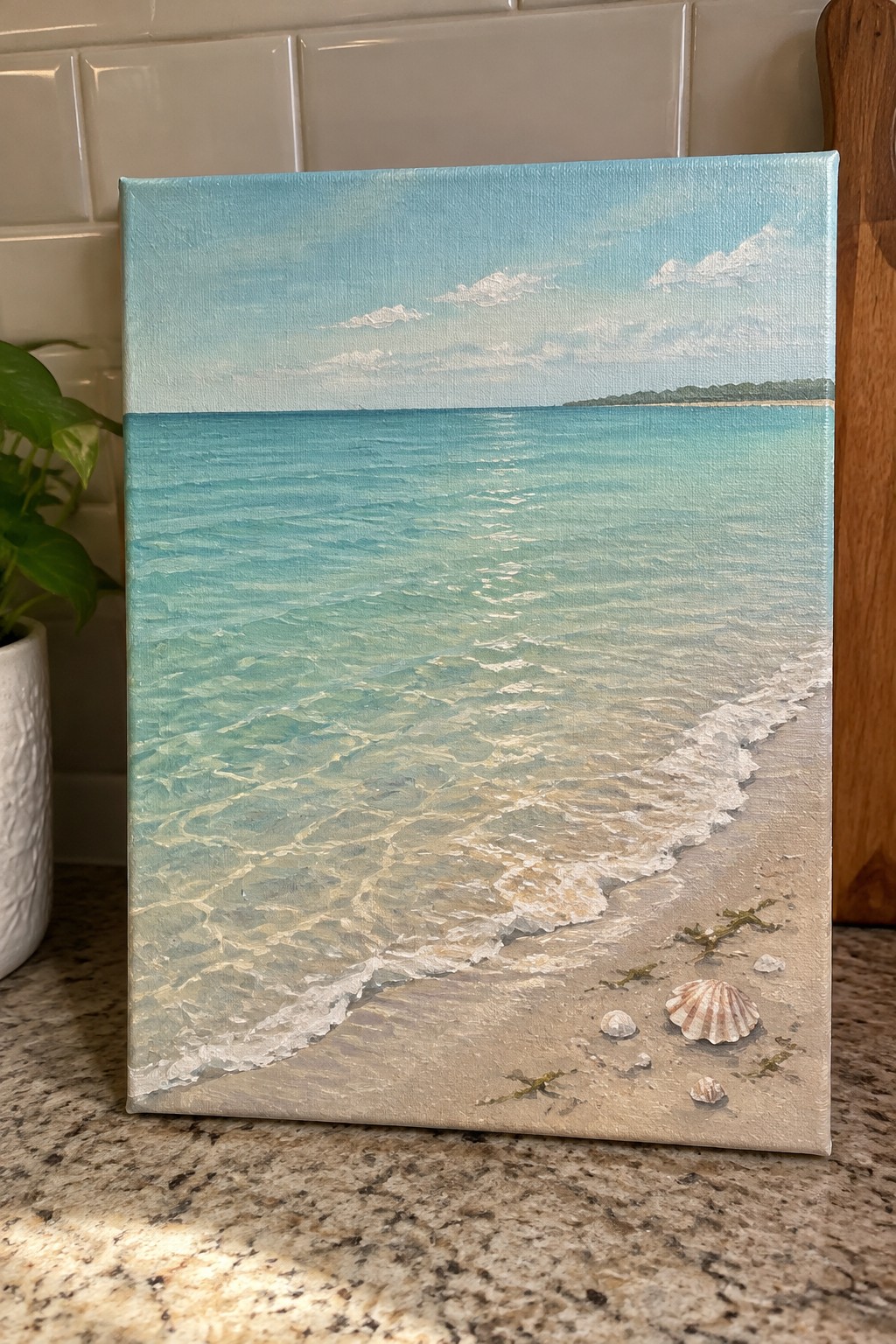 Canvas painting of turquoise ocean waves lapping onto sandy beach with seashells