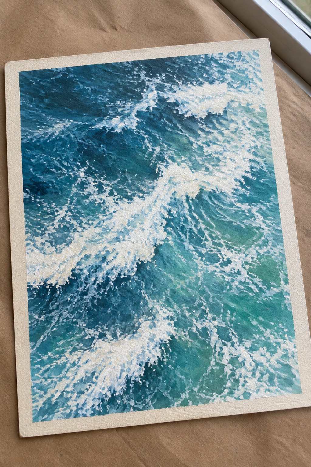 Watercolor painting of crashing blue-green ocean waves with white foam on paper