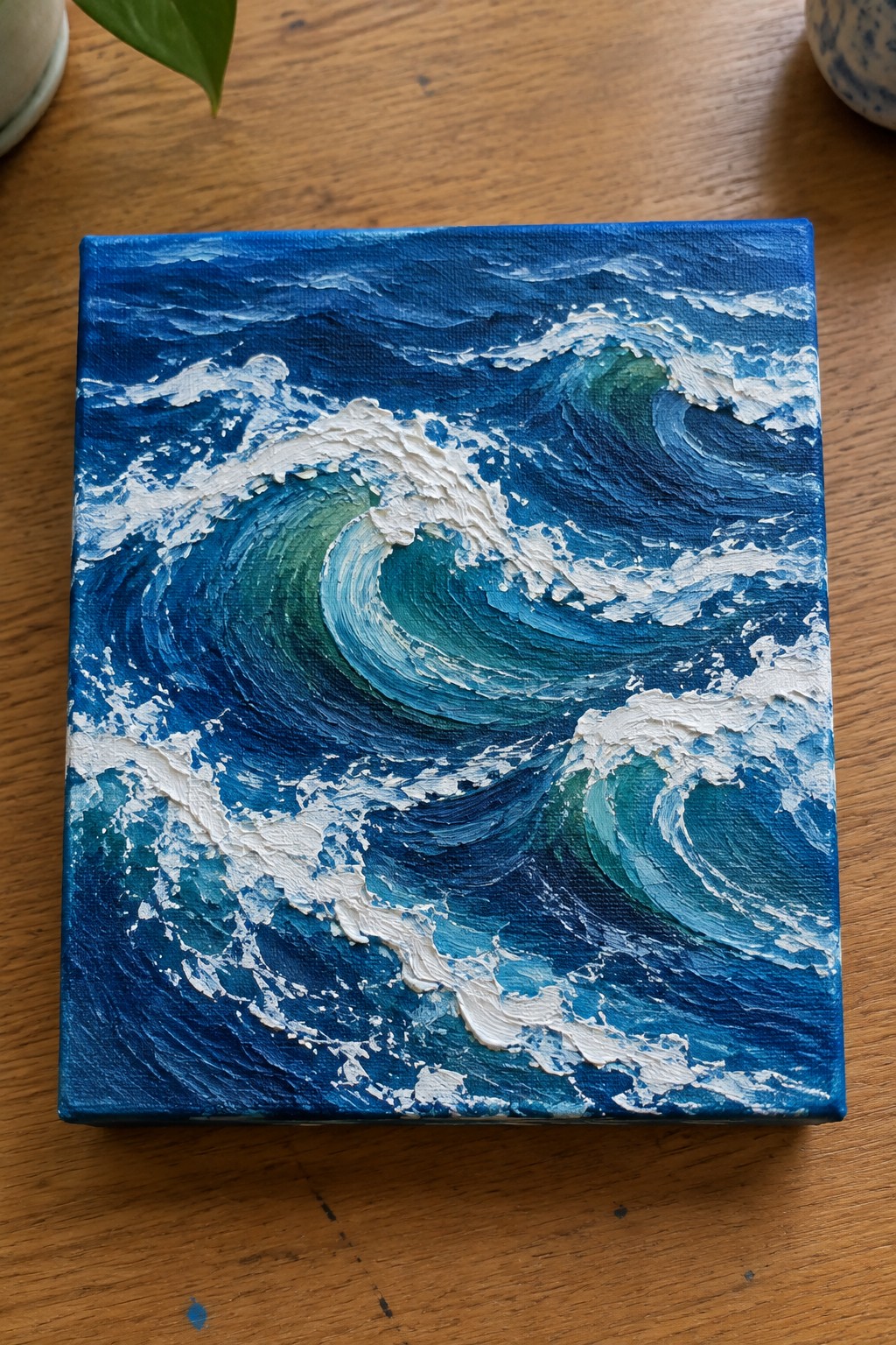 Impasto painting of crashing blue-green ocean waves with thick white foam on wood.