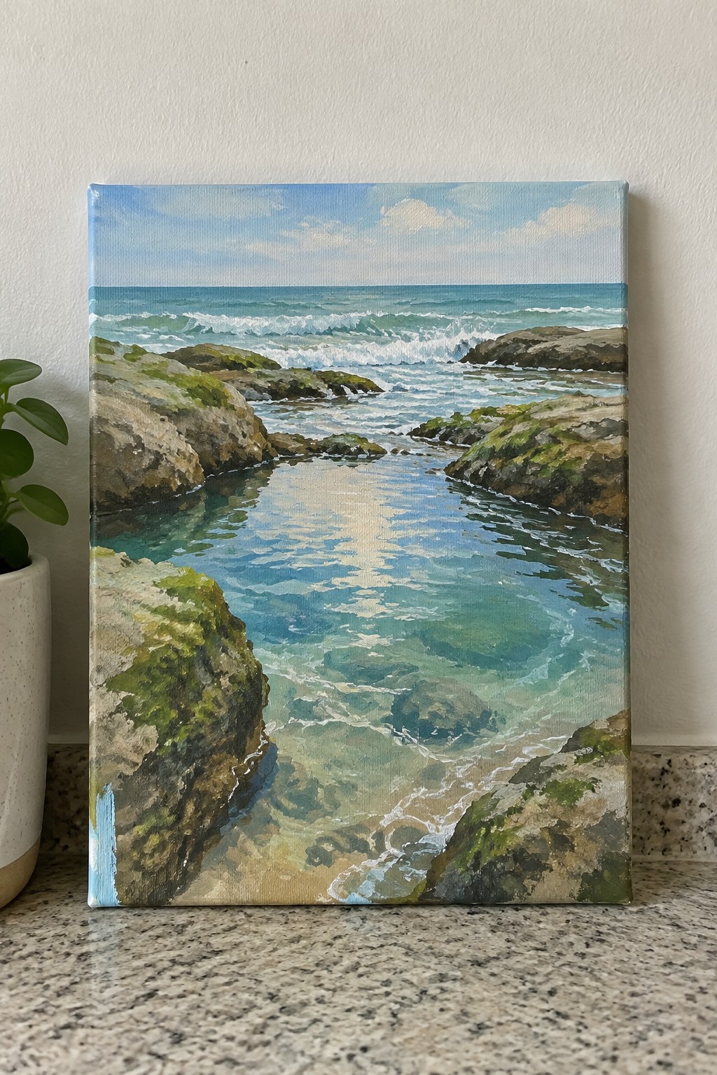 Rocky coastal cove painting with turquoise water, mossy rocks, and rolling ocean waves