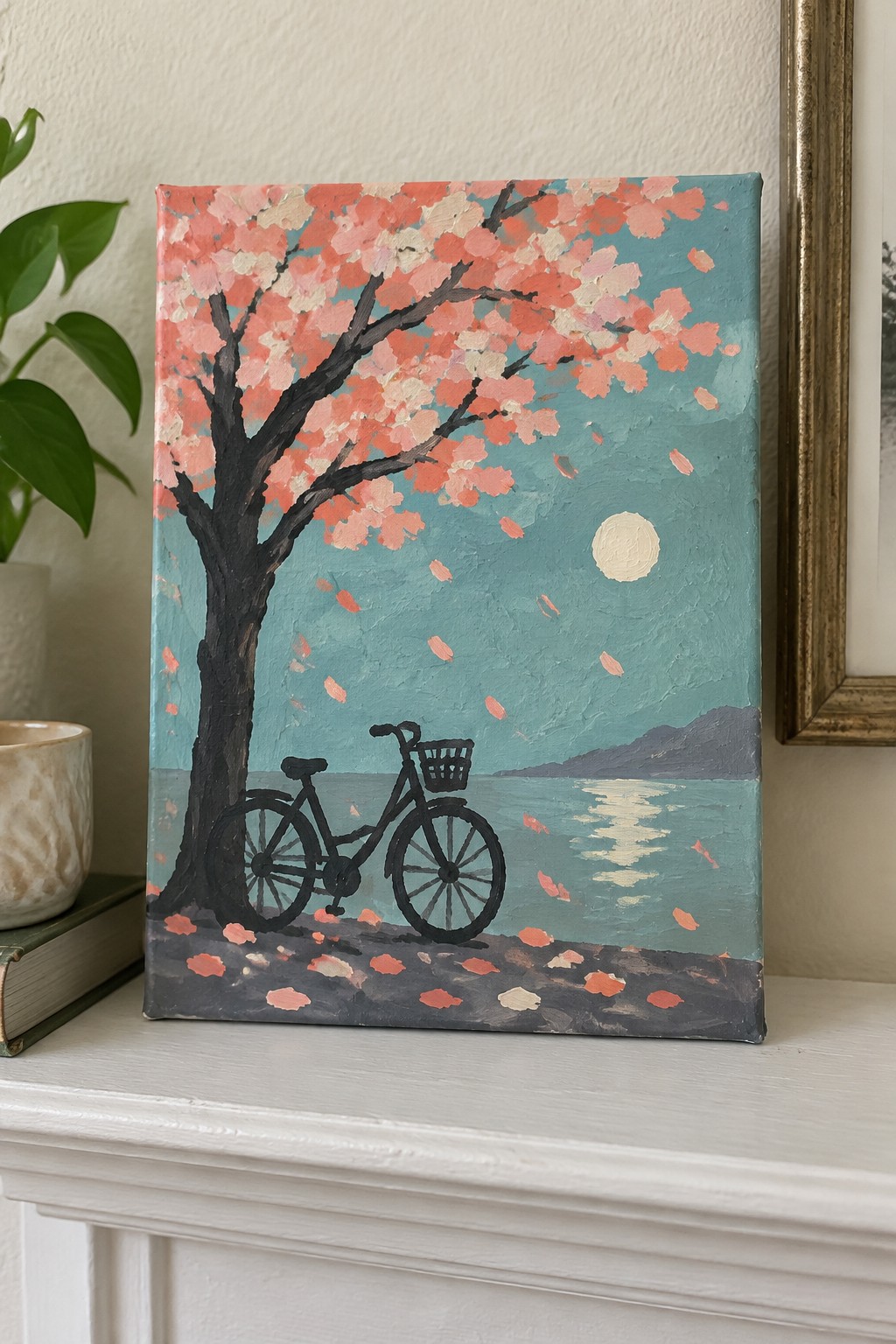Black bicycle under pink cherry blossoms by moonlit teal lake with falling petals