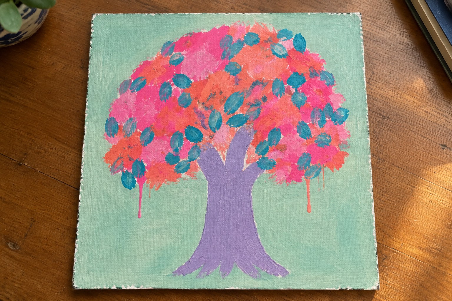 Vibrant acrylic painting of tree with purple trunk, pink-orange foliage, teal accents.