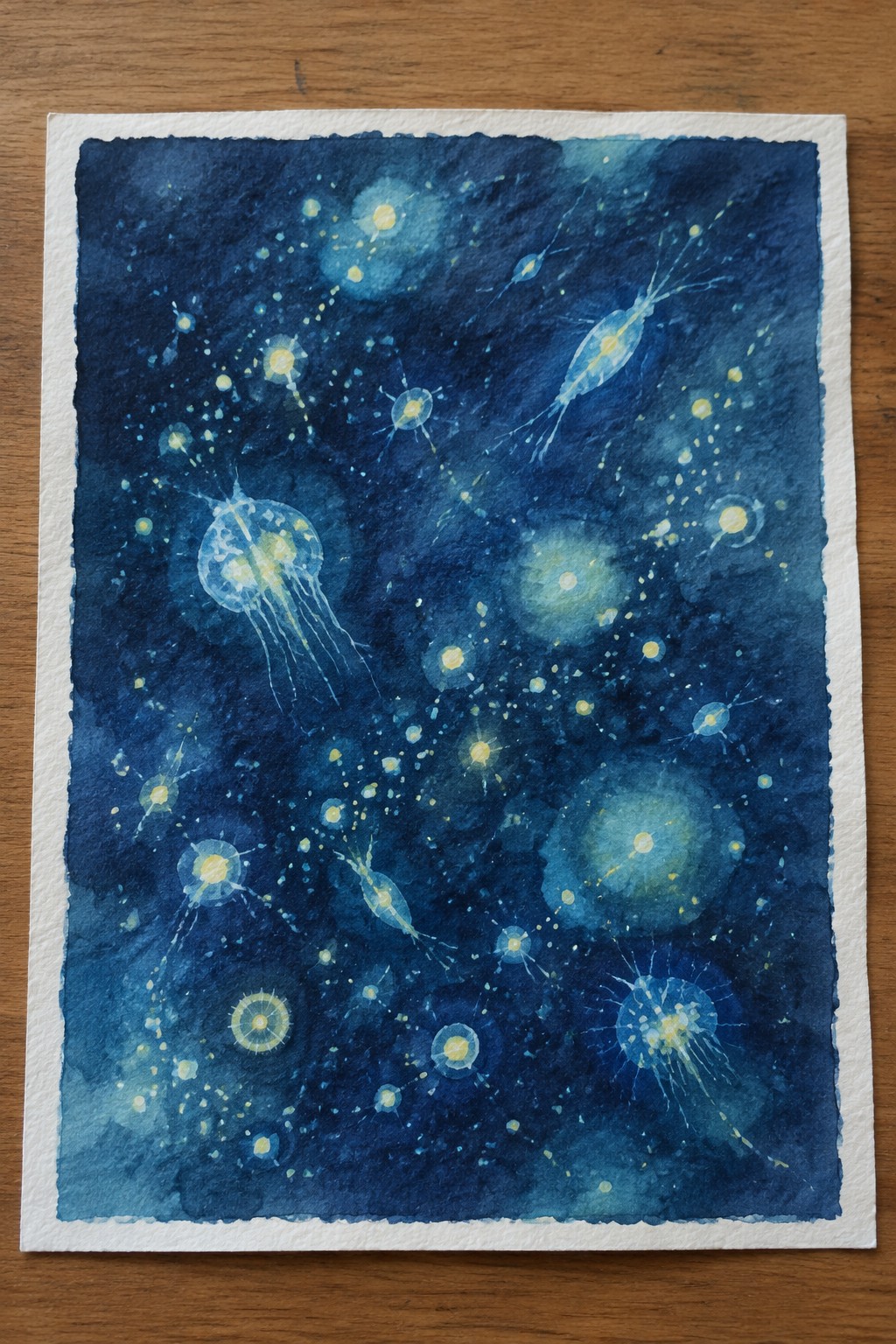 Watercolor painting of luminous jellyfish and plankton drifting in deep blue ocean