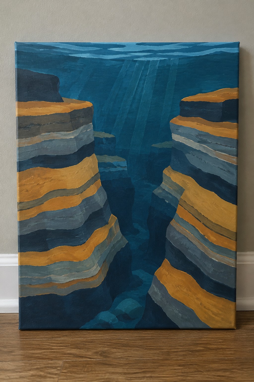 Layered orange and blue cliffs form an underwater canyon with sunlight rays penetrating deep water.