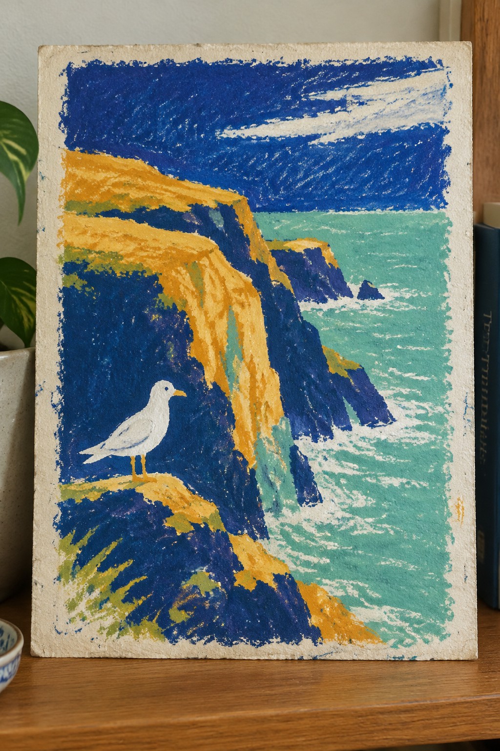 Vibrant painting of white seagull on yellow cliffs above turquoise sea and waves.