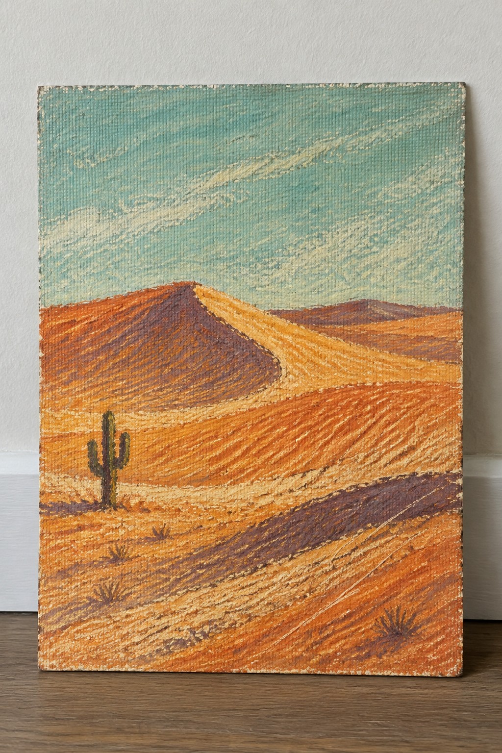 Orange sand dunes with saguaro cactus beneath streaky turquoise sky in textured painting