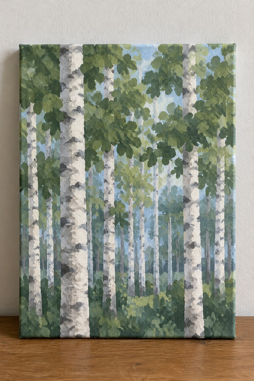 Canvas painting of birch forest with white trunks, green leaves, and blue sky.