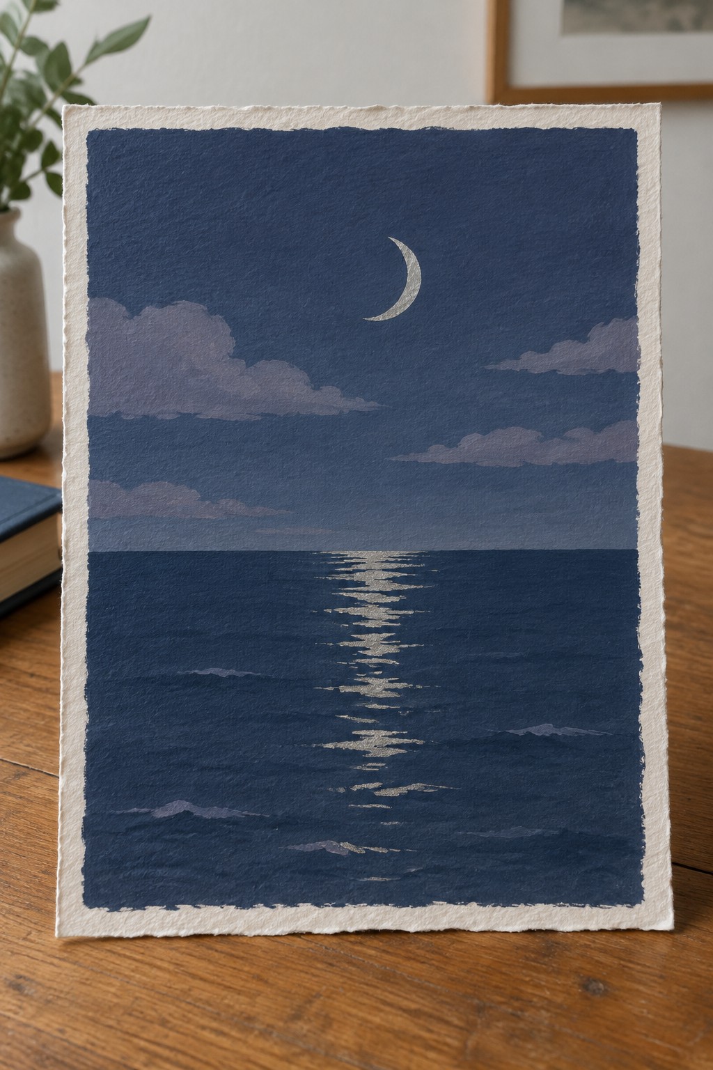 Watercolor seascape of crescent moon reflecting on dark blue ocean under cloudy night sky