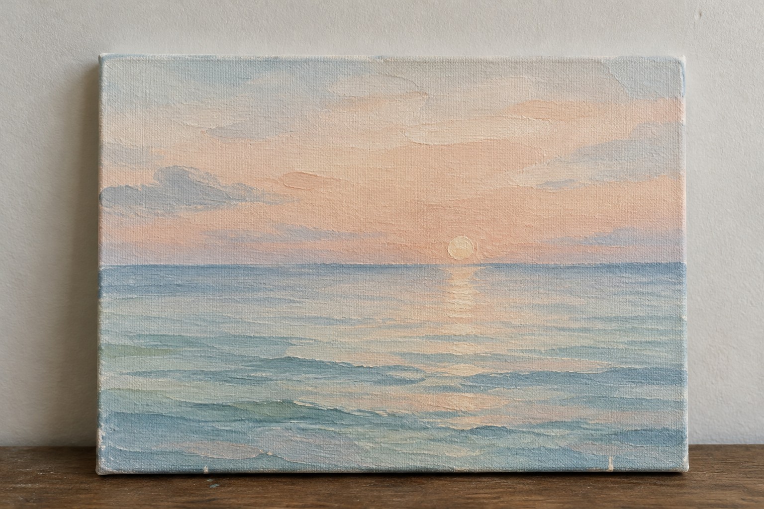 A canvas painting of a calm ocean at sunset with a low sun, soft pink and blue sky, and gentle blue-green waves reflecting the light.