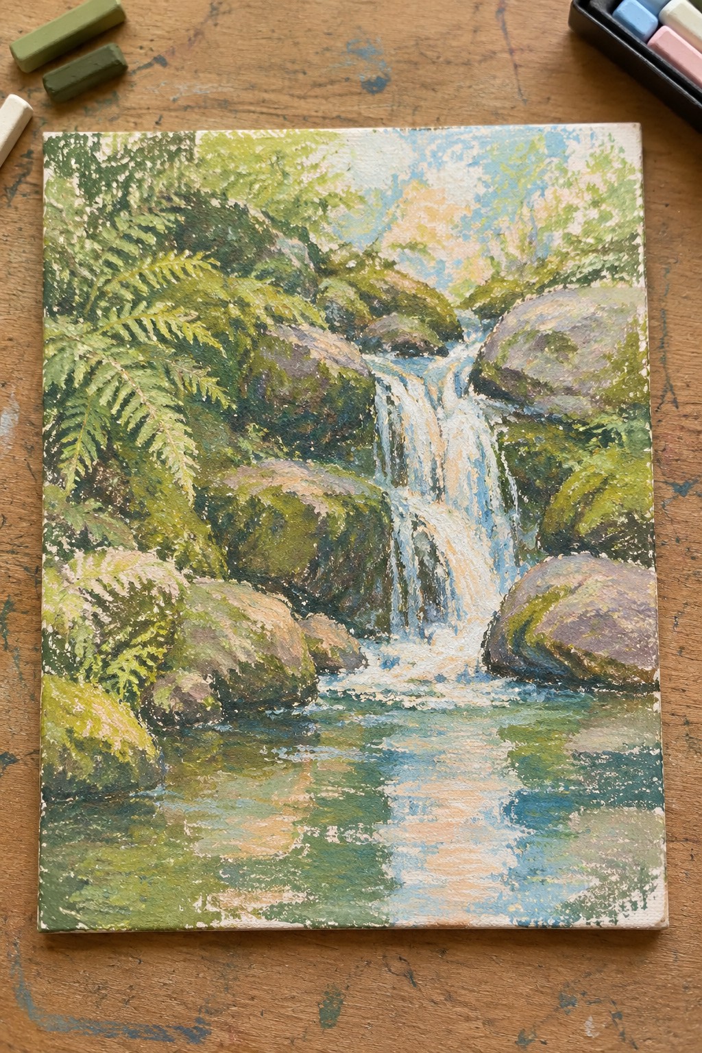 Colorful pastel painting of waterfall cascading over mossy rocks amid green ferns