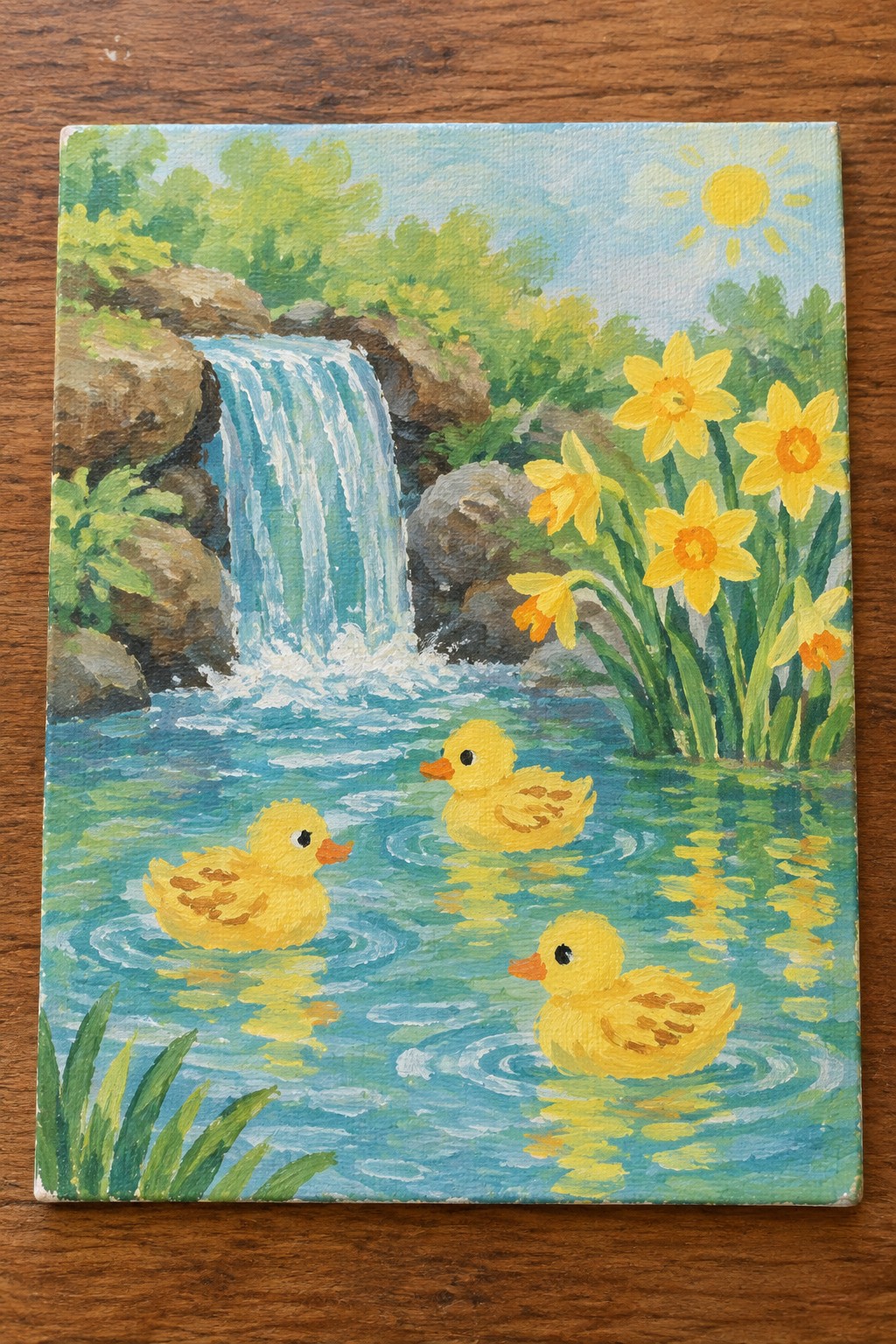 Three yellow ducklings swim near a waterfall with daffodils under a bright sun