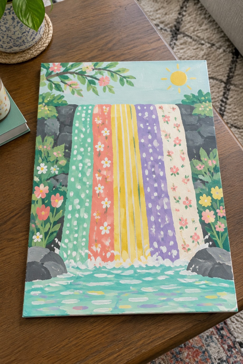 Bright rainbow waterfall painting with colorful stripes, flowers, rocks, and turquoise pool