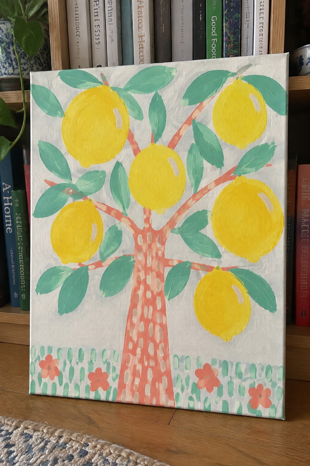 Colorful folk-style painting of lemon tree with yellow fruits, red trunk, and floral border