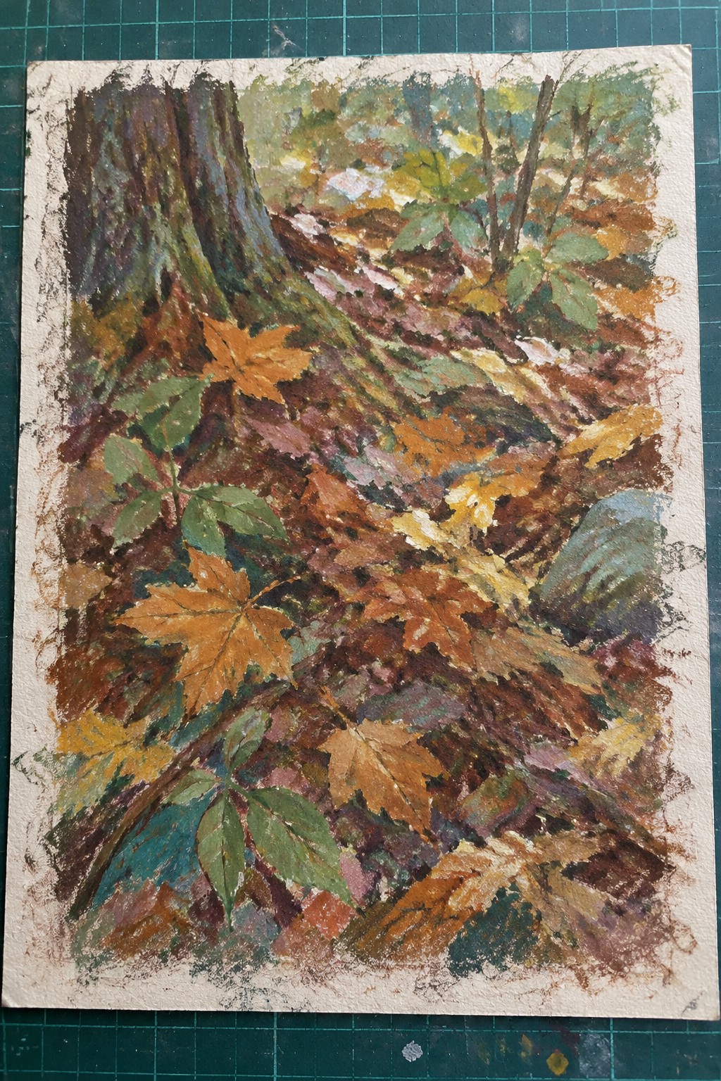 Autumn forest floor painting with vibrant orange, brown, and green fallen leaves beside tree trunk