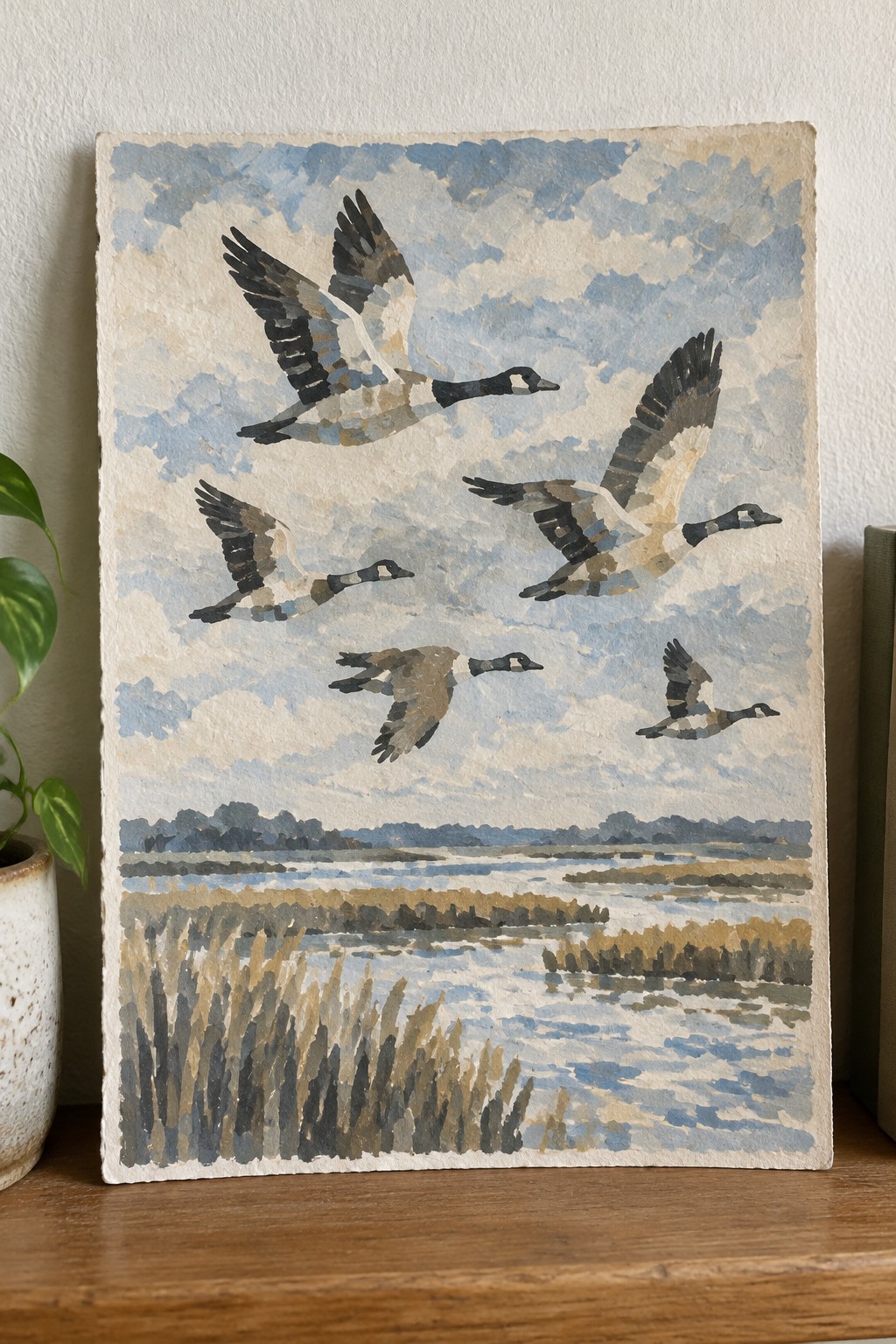 Watercolor painting of five geese flying over marshy wetland with reeds and water