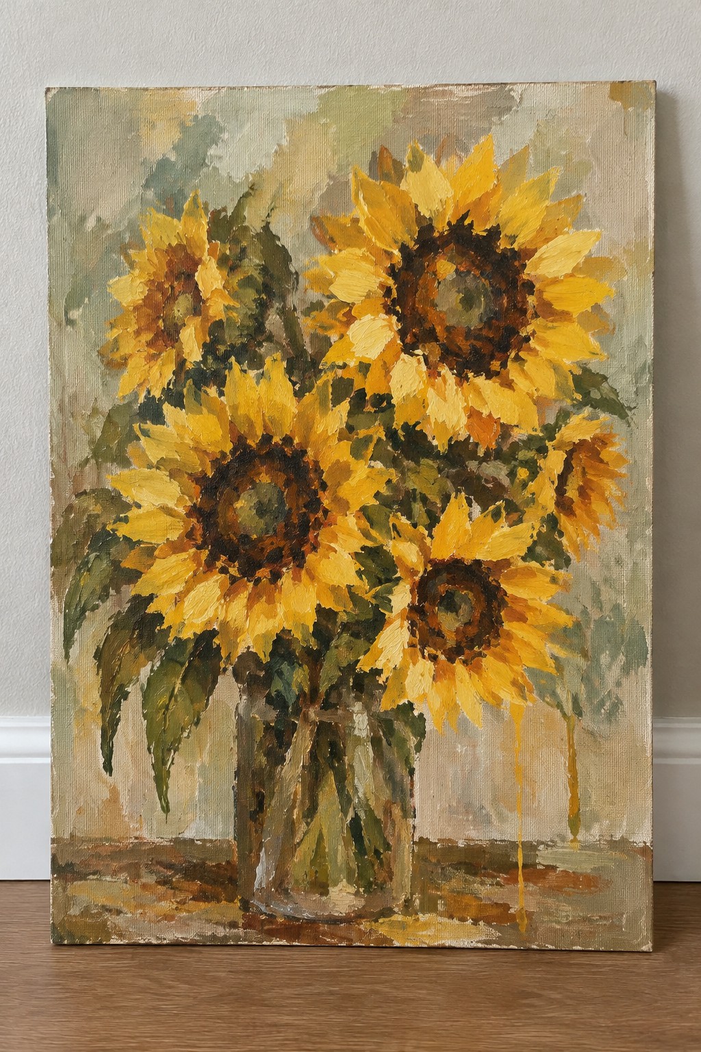 Impressionist painting of yellow sunflowers in a glass vase on a wooden surface.