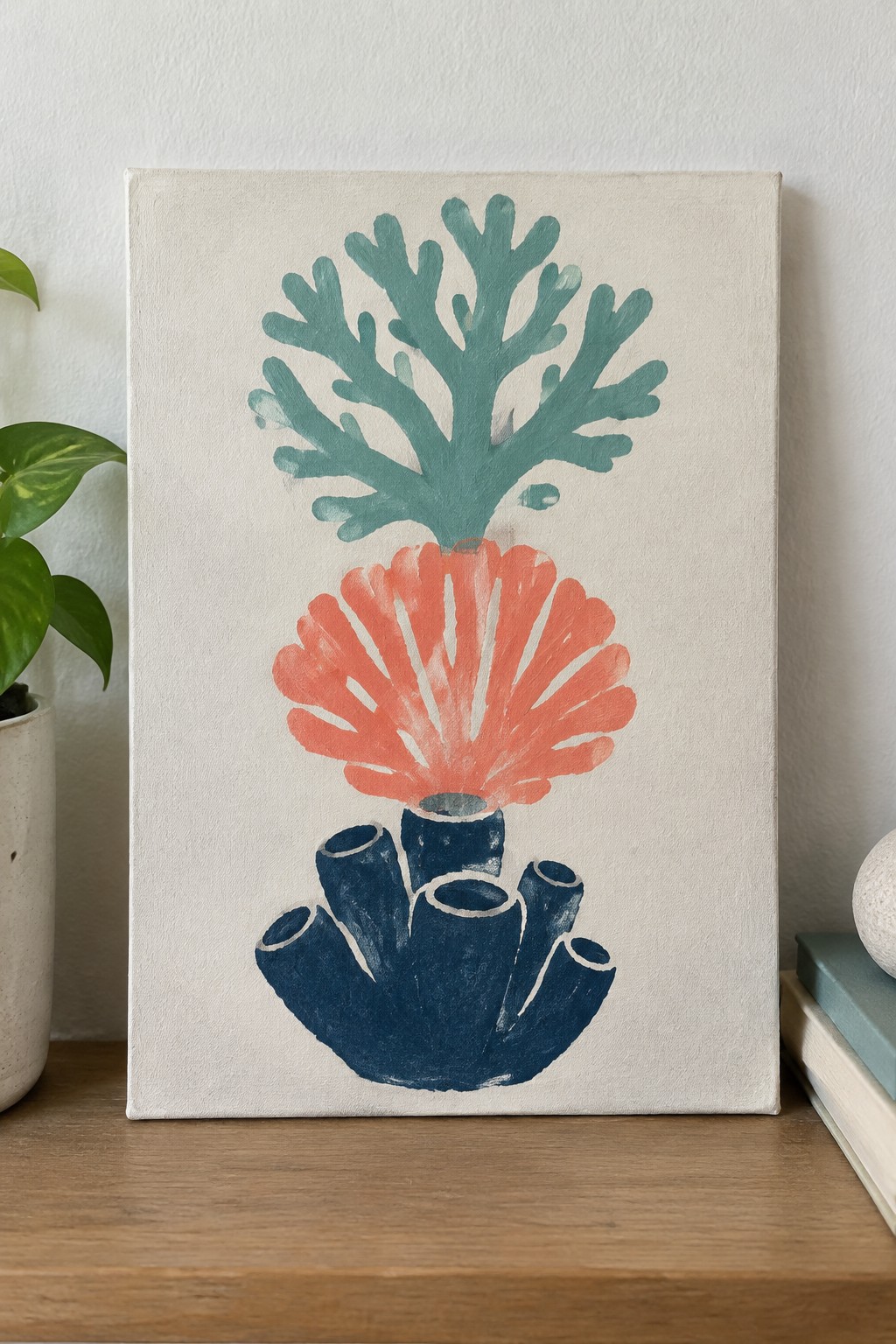 Abstract canvas painting of teal, orange, and navy coral shapes