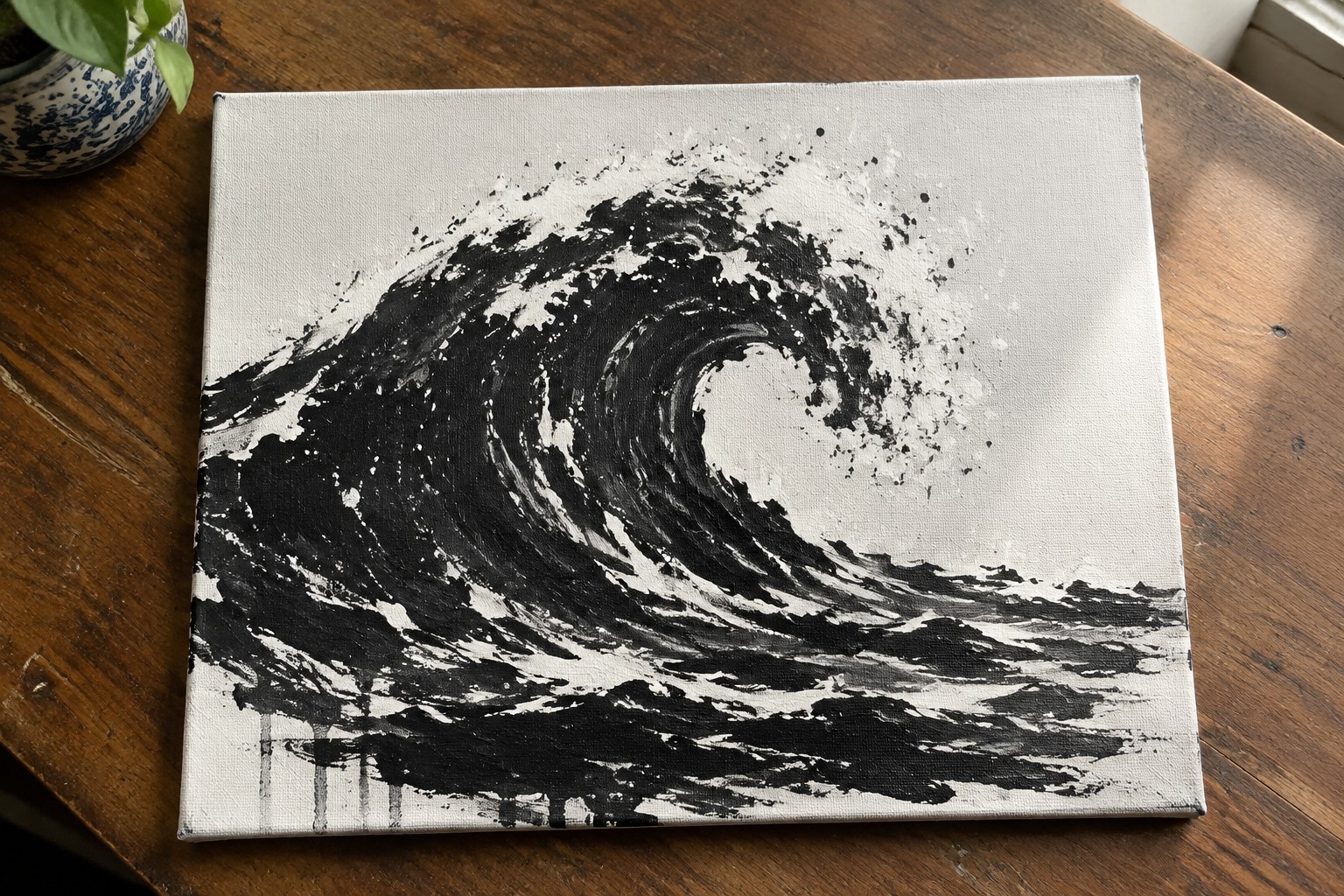 Abstract black and white wave painting with splatters and drips on canvas