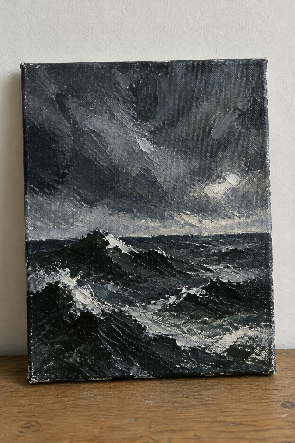 Thickly textured painting of dark stormy waves crashing under heavy gray clouds