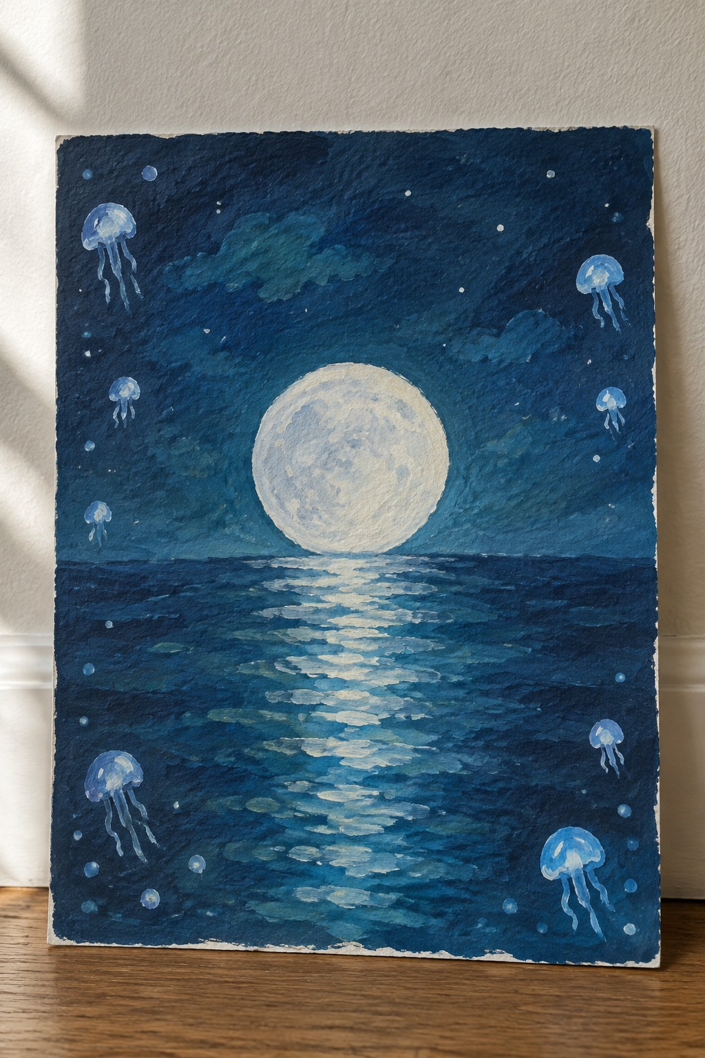 Textured painting of full moon reflecting on ocean with floating blue jellyfish.