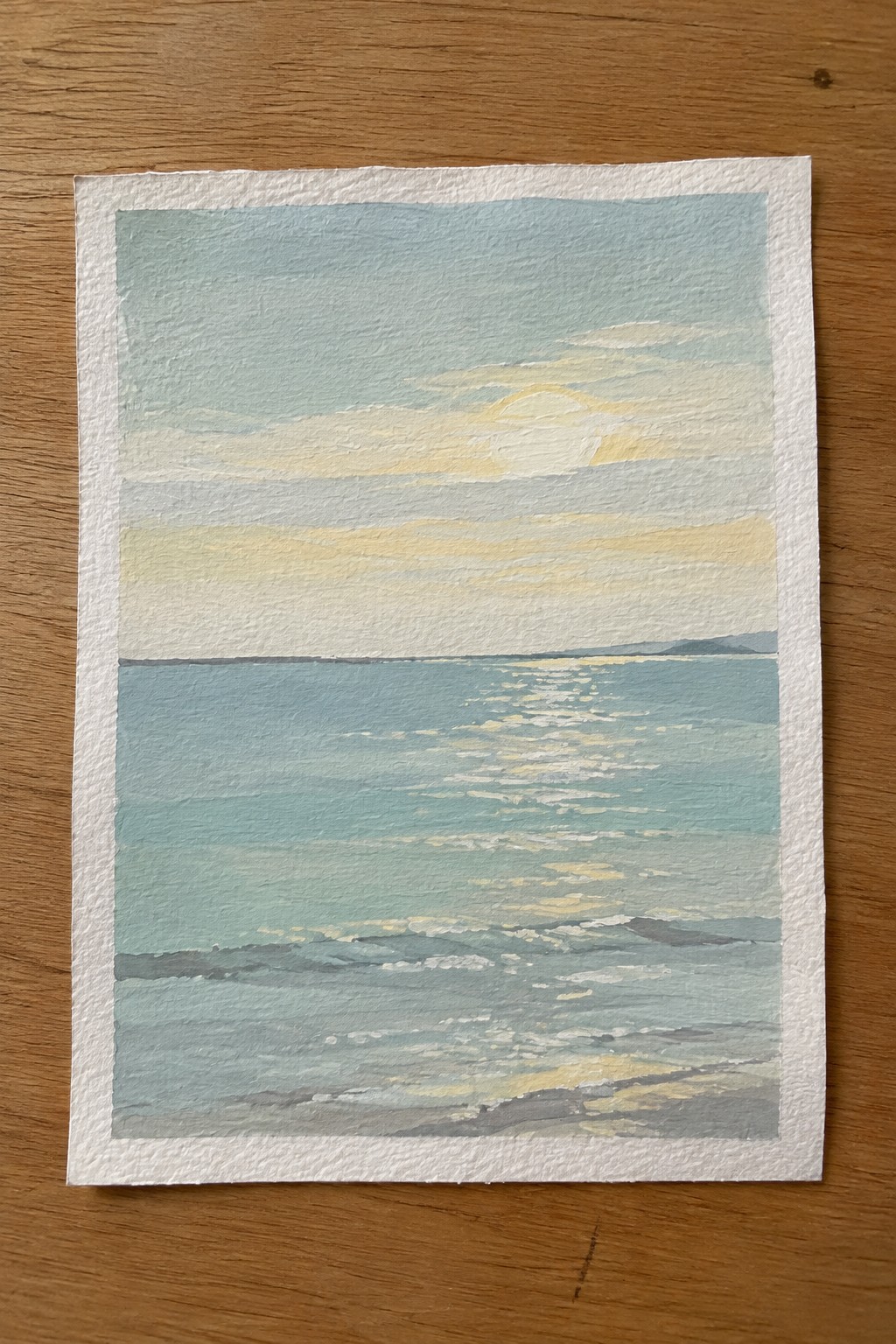 Watercolor seascape of turquoise waves reflecting yellow sunlight beneath a cloudy sky