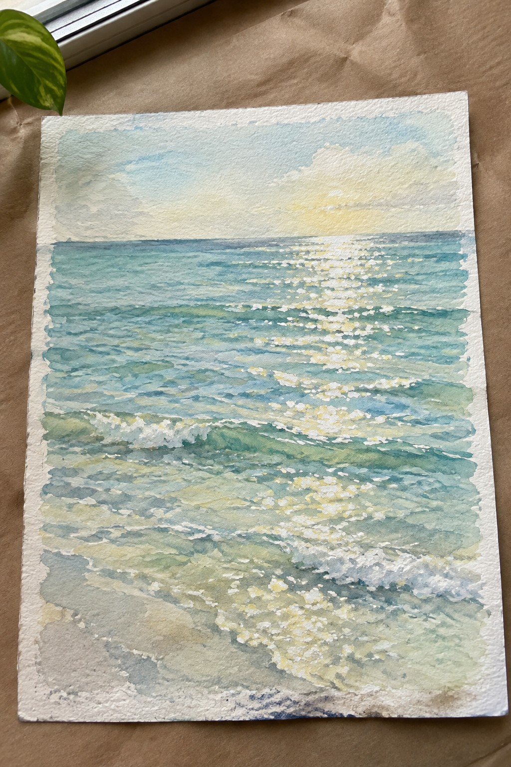 Watercolor seascape of turquoise waves with white foam and golden sunlight reflections on paper