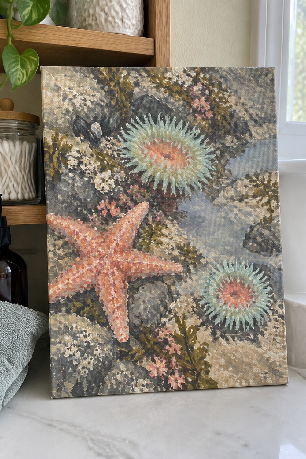 Painting of orange starfish and turquoise anemones on rocky ocean floor
