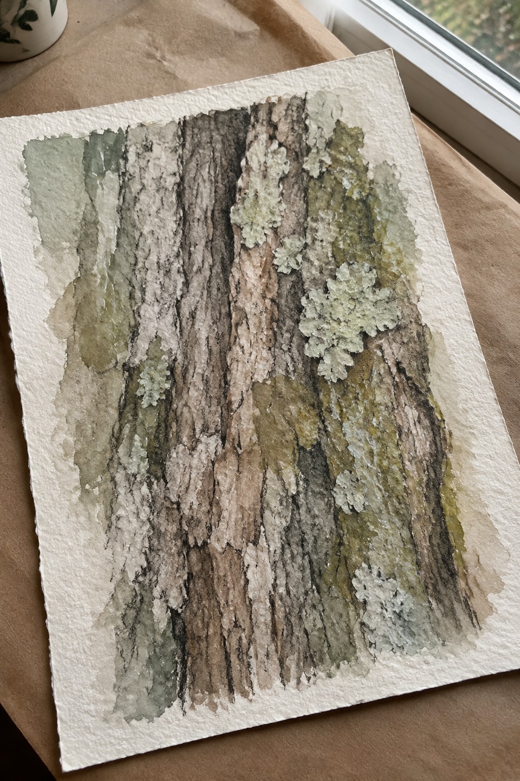 Watercolor of textured tree bark in browns with green lichen patches on paper