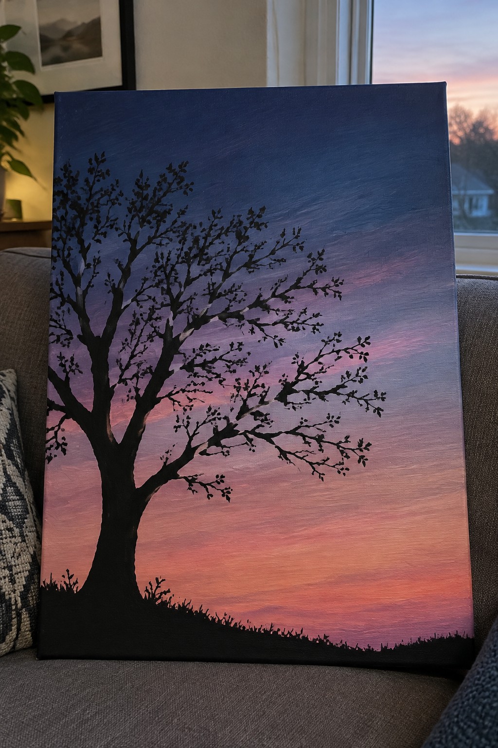 Canvas painting of black tree silhouette against pink orange blue sunset gradient