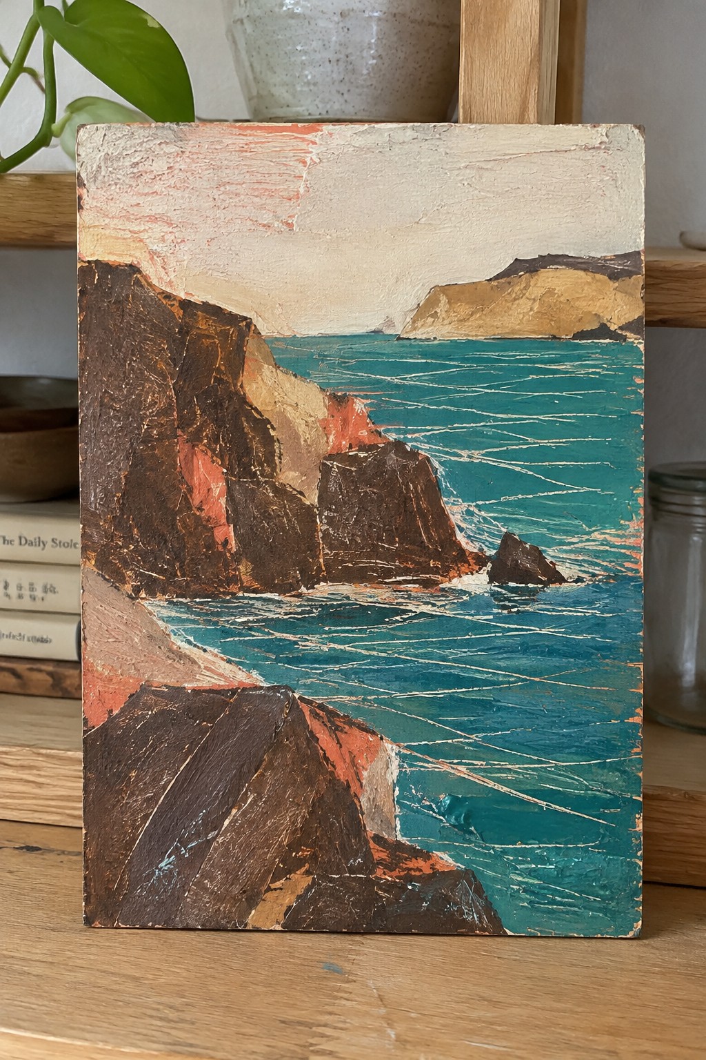 Textured painting of rugged brown cliffs by turquoise sea with white wave lines
