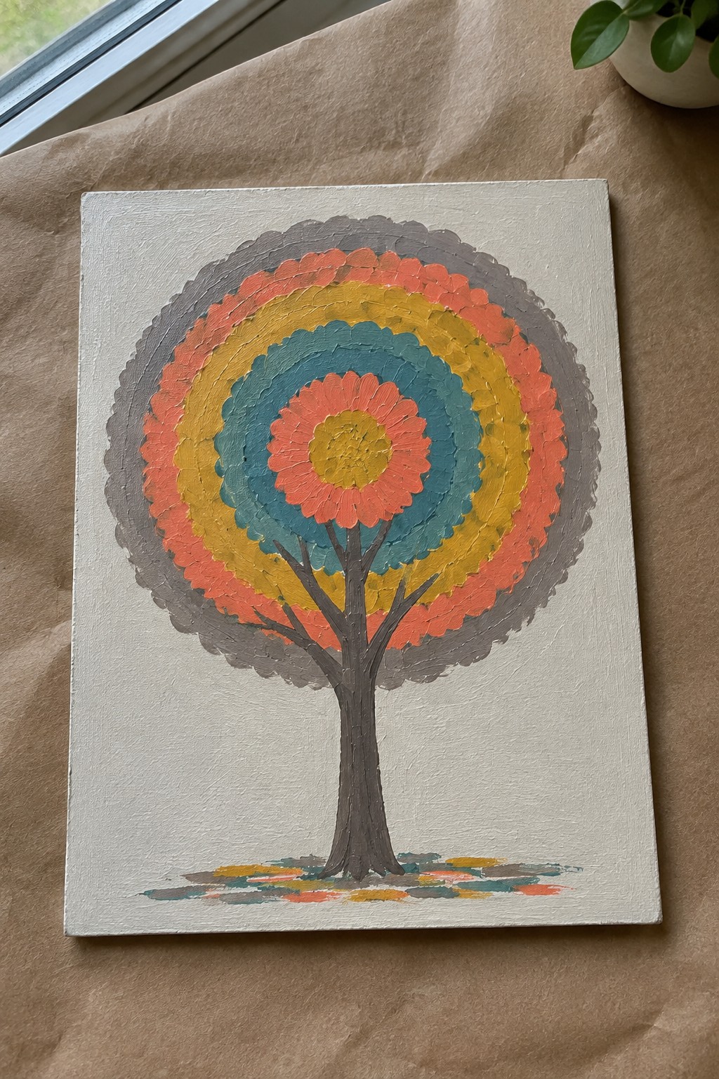 Colorful tree painting with concentric scalloped rings in gray, coral, yellow, and teal.