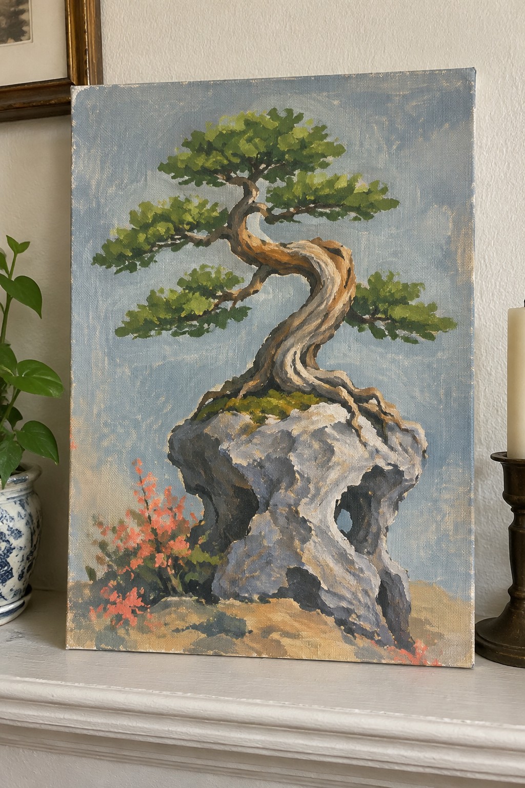 Painting of twisted bonsai tree on gray rock with red flowers on white mantel