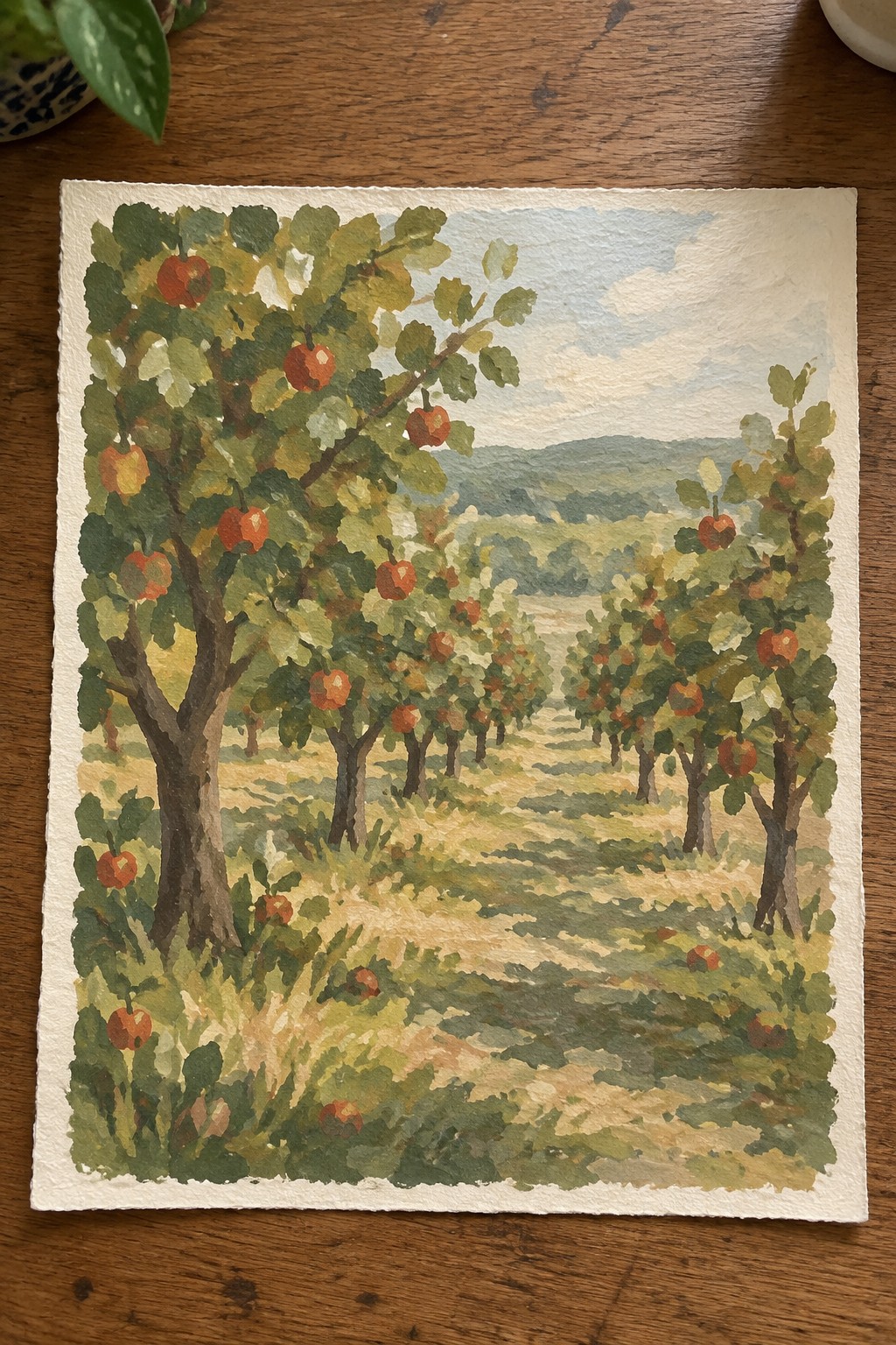 A watercolor painting of an apple orchard with rows of trees bearing red and yellow apples along a dirt path leading toward distant hills.