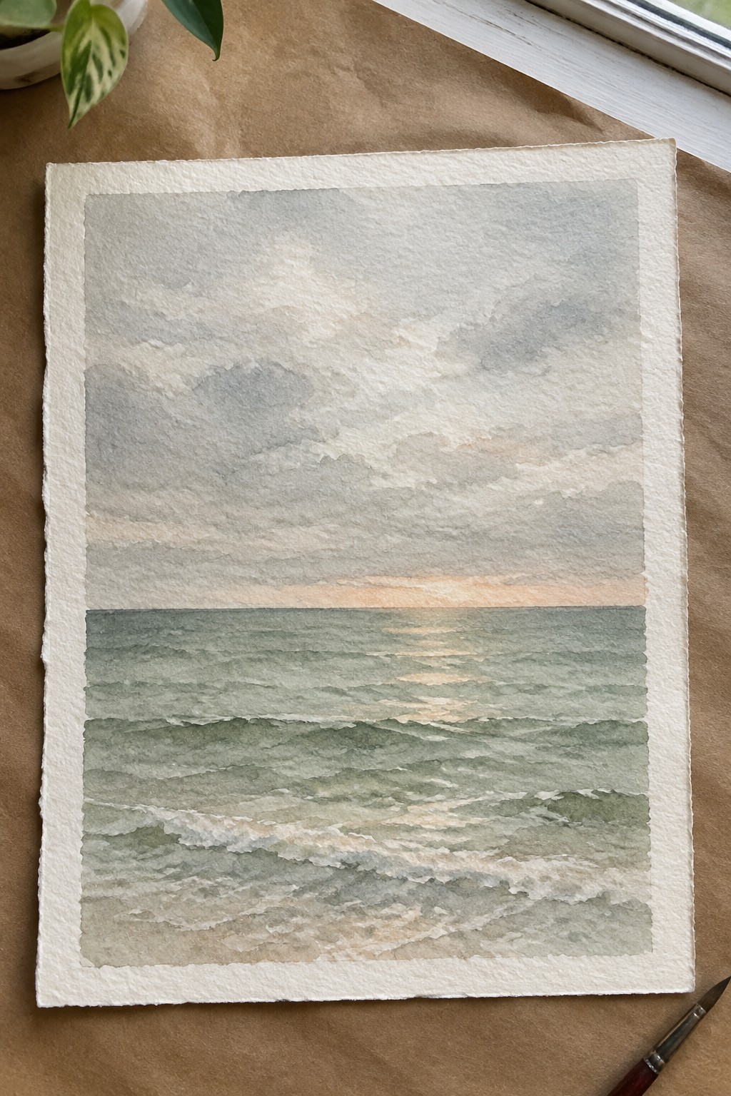 Watercolor seascape of green waves under gray clouds with pink sunset horizon on paper