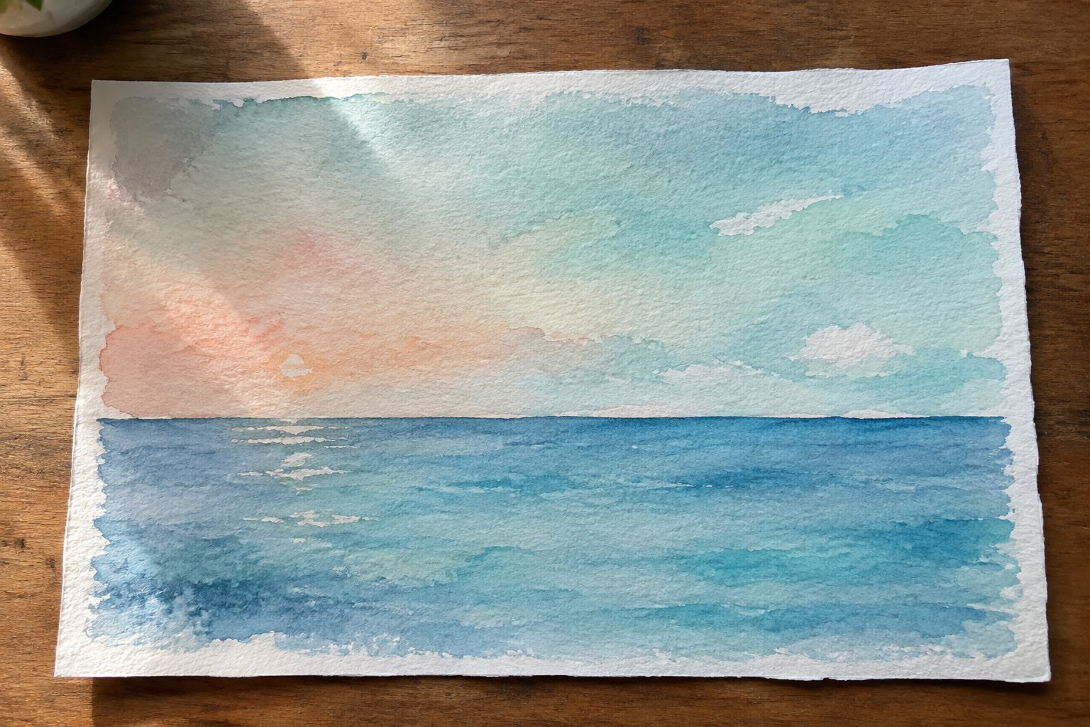 Watercolor seascape of blue ocean waves beneath pink and blue sunset sky on wood