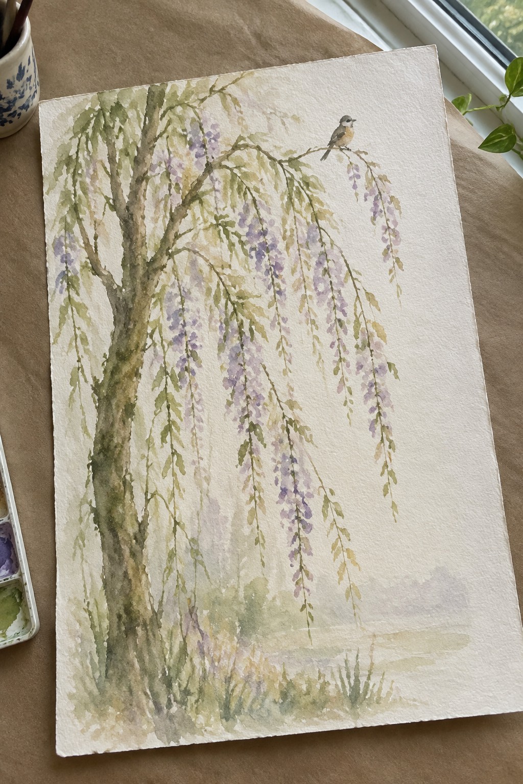Watercolor of wisteria tree with hanging purple flowers and bird on branch