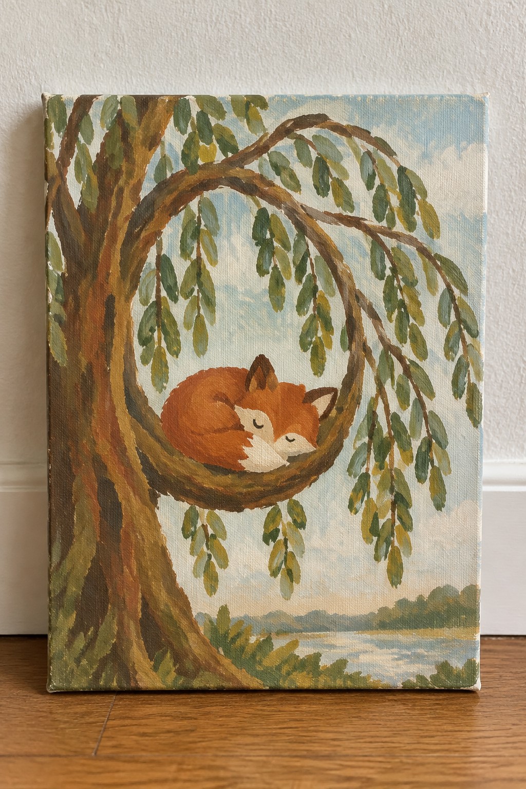 A painting of a sleeping fox curled in the branches of a willow tree overlooking a body of water.