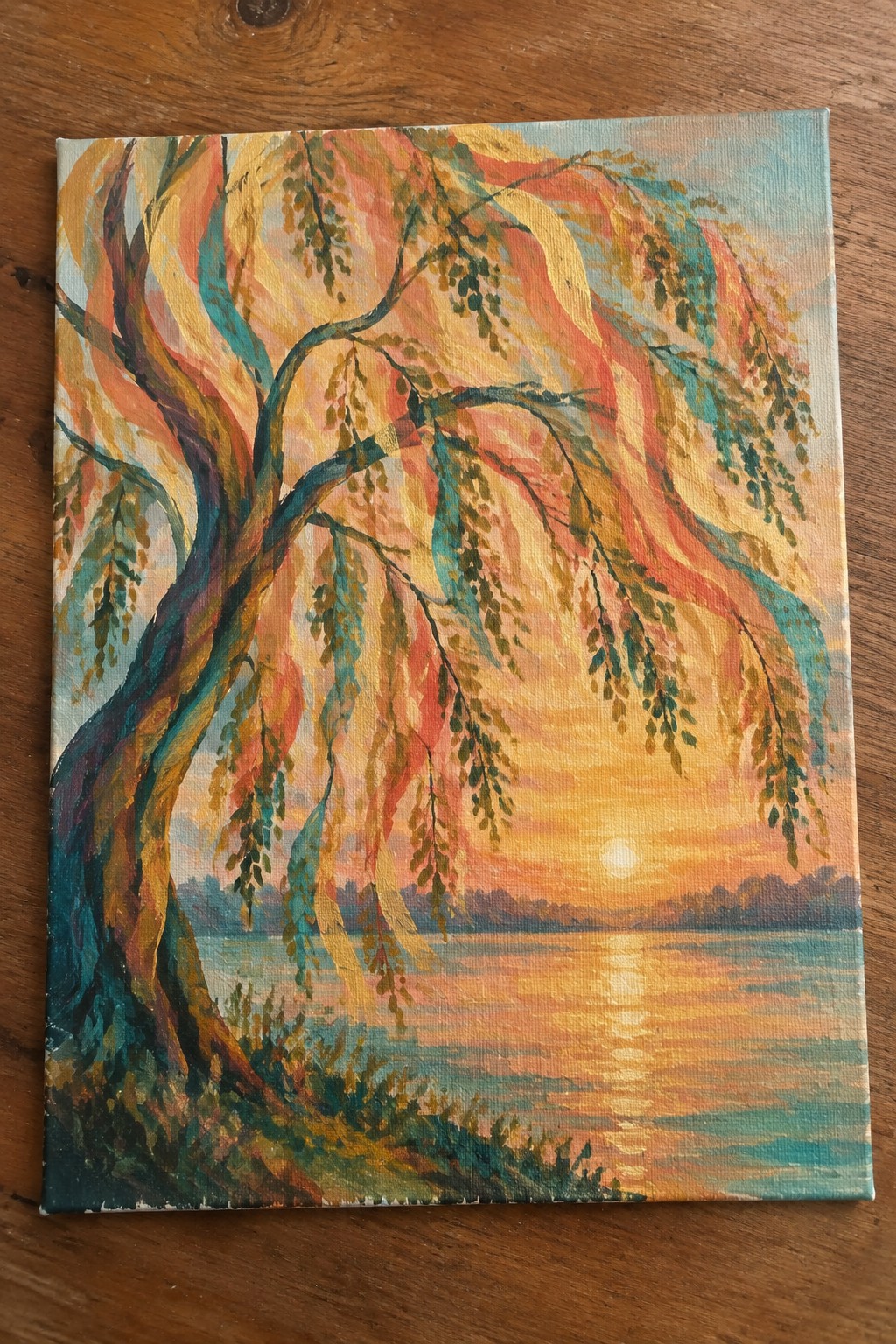 Colorful painting of a twisted tree with hanging leaves over a sunset lake