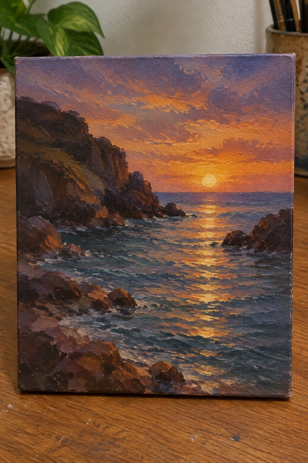 Oil painting of sunset over rocky cliffs with golden ocean waves and clouds