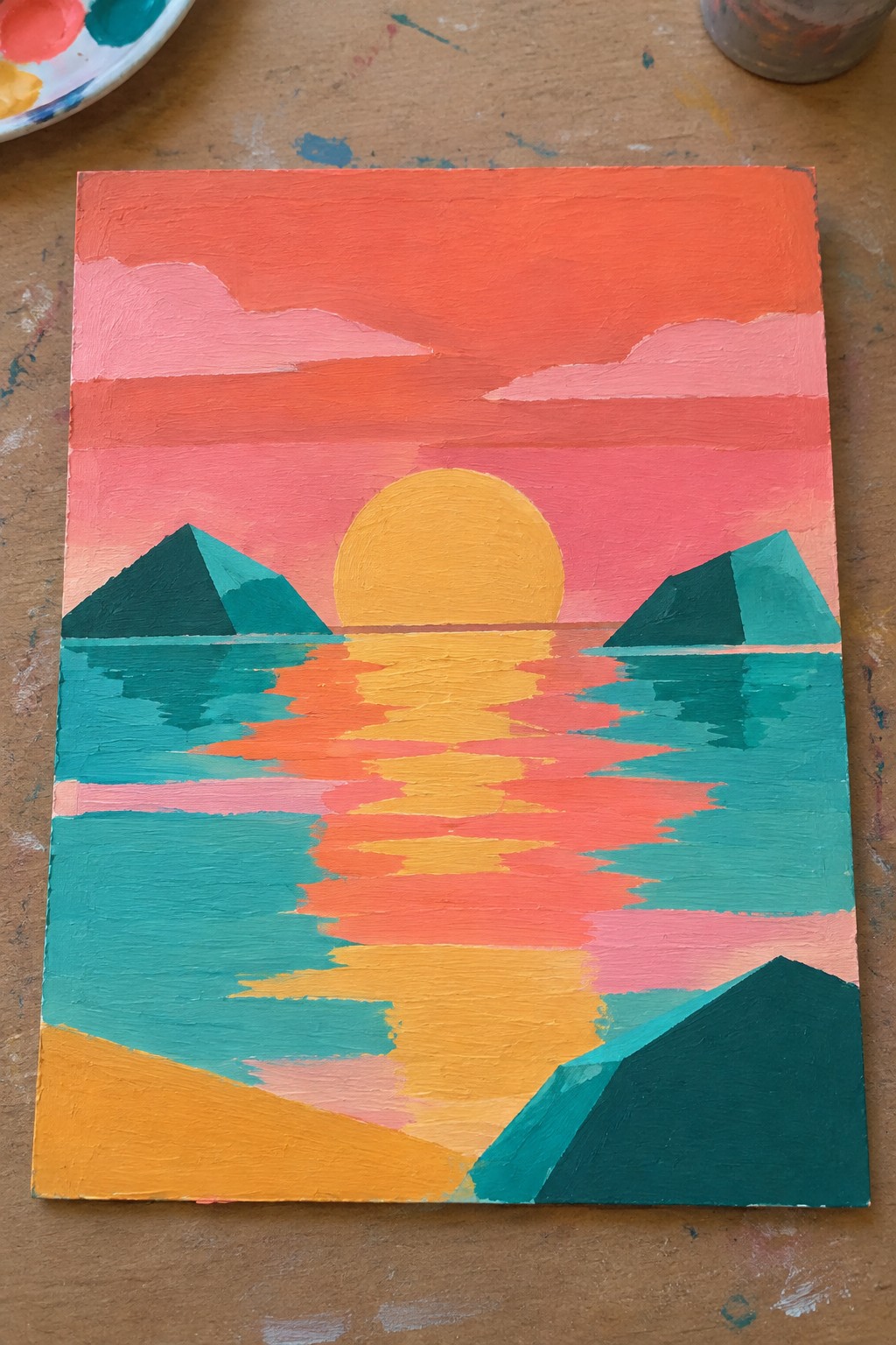 Vibrant abstract sunset painting with yellow sun, pink sky, teal water, and green mountains.
